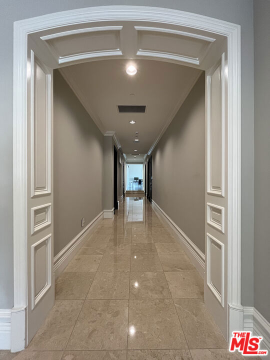 corridor featuring ornamental molding