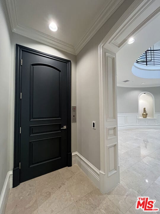 doorway to outside with ornamental molding