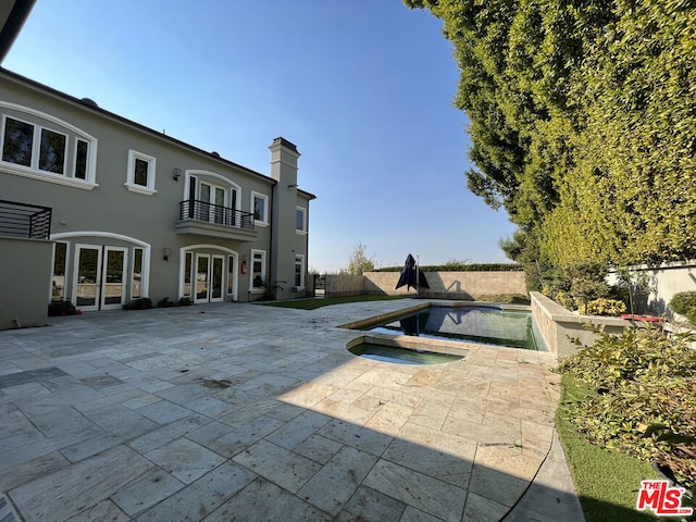 view of pool featuring an in ground hot tub, a patio area, and french doors