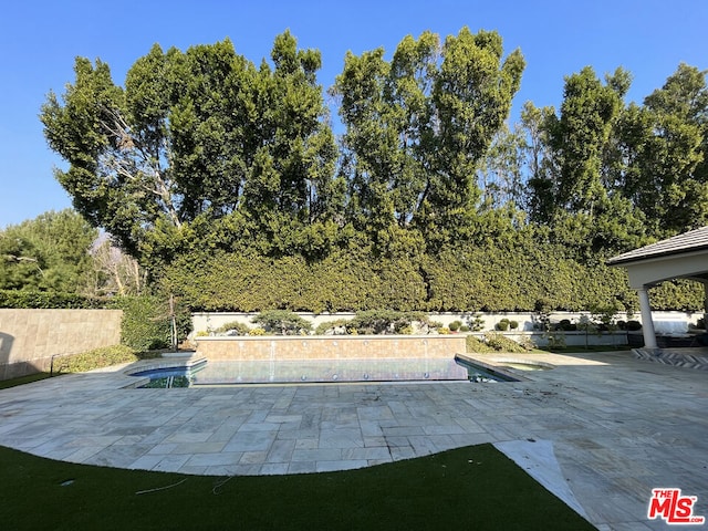 view of patio with a fenced in pool