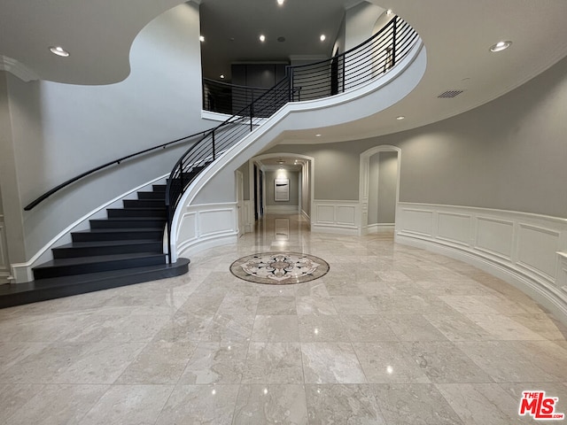 foyer entrance featuring a towering ceiling