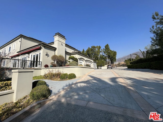 view of side of home with a mountain view