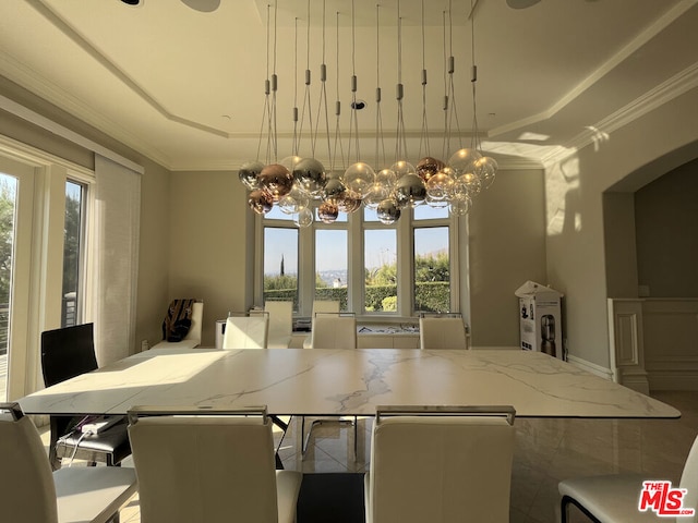 dining area featuring ornamental molding, plenty of natural light, and a tray ceiling