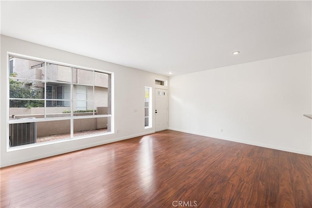 spare room featuring wood-type flooring