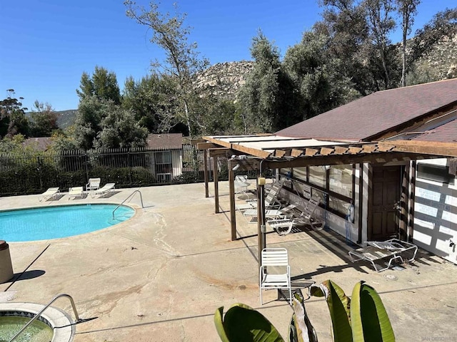 view of pool with a pergola and a patio area