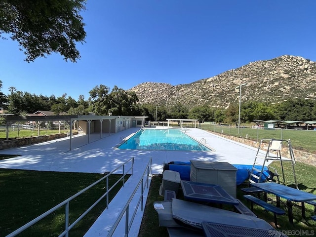 view of swimming pool with a mountain view