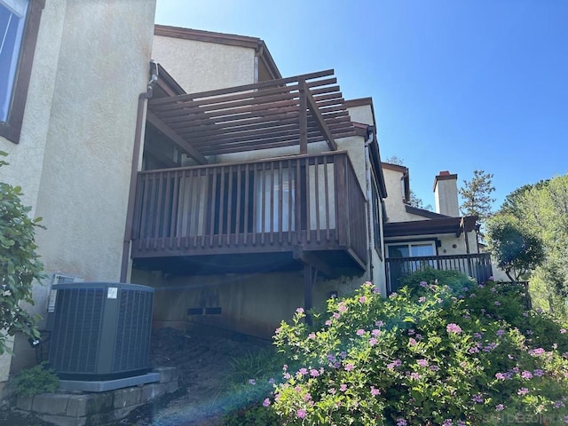 exterior space with a balcony, a pergola, and central air condition unit