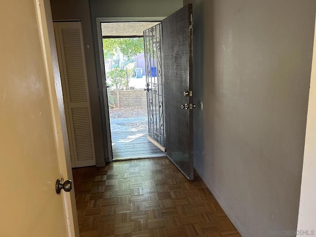 entryway with dark parquet flooring