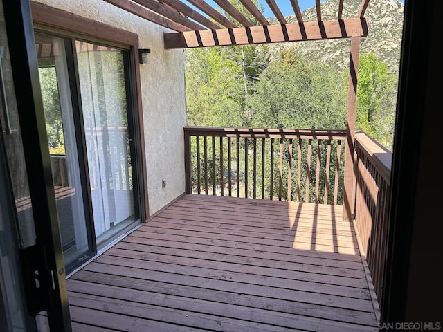 wooden deck featuring a pergola