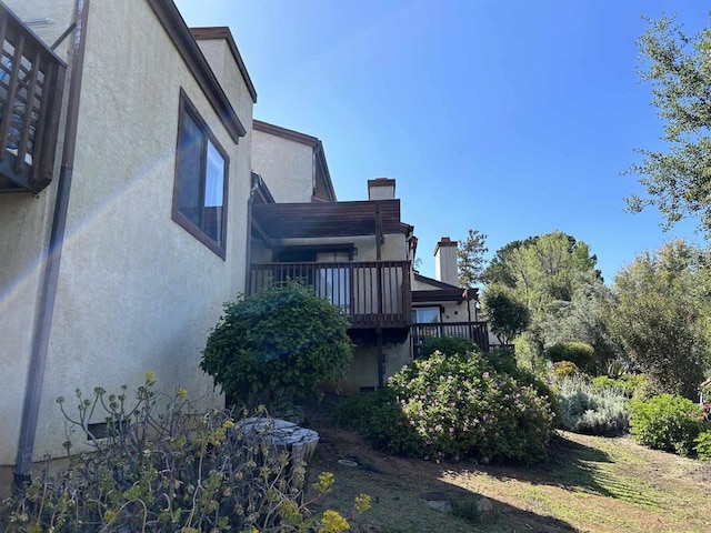 view of property exterior with a balcony