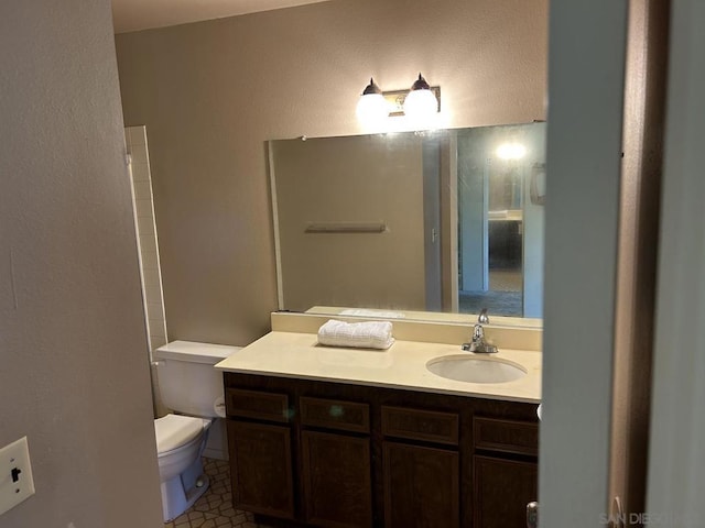 bathroom with vanity, toilet, and tile patterned floors