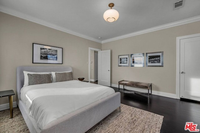 bedroom with dark wood-type flooring and ornamental molding