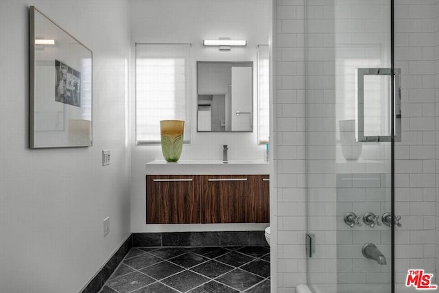 bathroom featuring vanity, toilet, and walk in shower