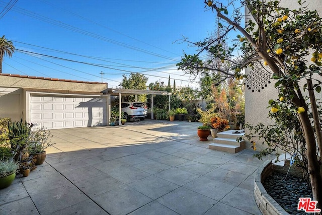 view of patio / terrace featuring a garage and a carport