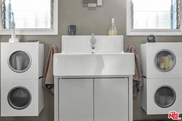 laundry room featuring stacked washer / drying machine