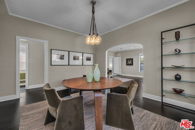 dining area featuring dark wood-type flooring and ornamental molding