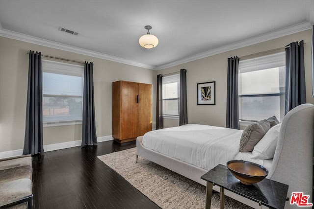 bedroom with dark hardwood / wood-style flooring and crown molding