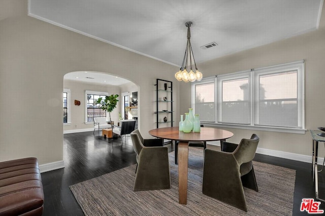 dining room featuring dark wood-type flooring and ornamental molding