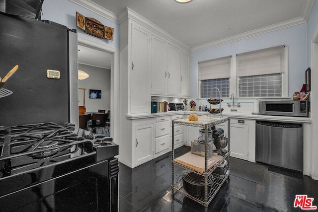 kitchen with white cabinets, appliances with stainless steel finishes, and crown molding