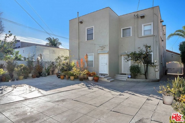 back of property featuring a patio