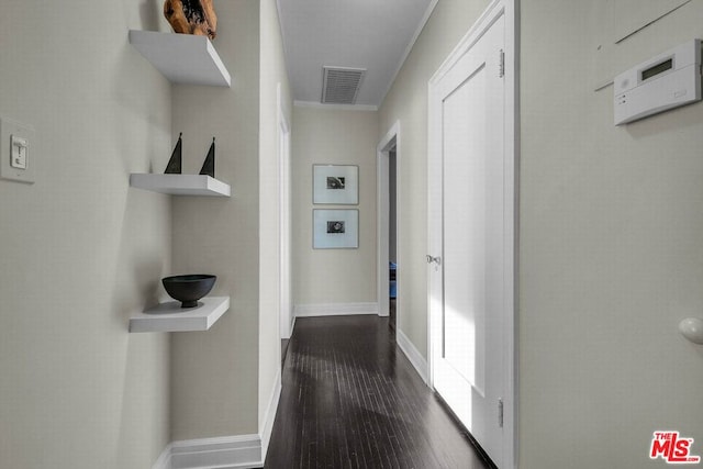 hall featuring crown molding and dark wood-type flooring