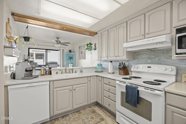 kitchen with ceiling fan, beamed ceiling, white appliances, sink, and backsplash