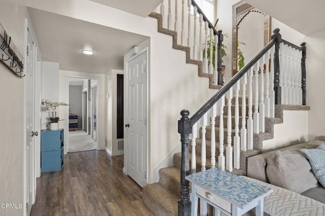 stairway featuring wood-type flooring