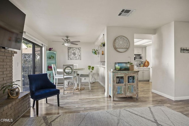 dining space featuring hardwood / wood-style floors and ceiling fan