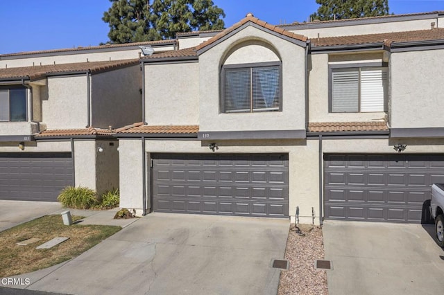 townhome / multi-family property featuring a garage