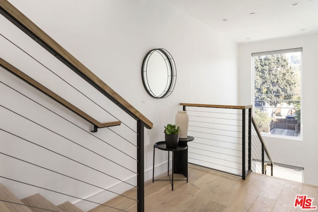 stairs featuring wood-type flooring