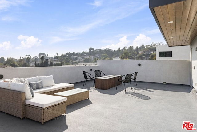 view of patio / terrace with an outdoor hangout area and a hot tub