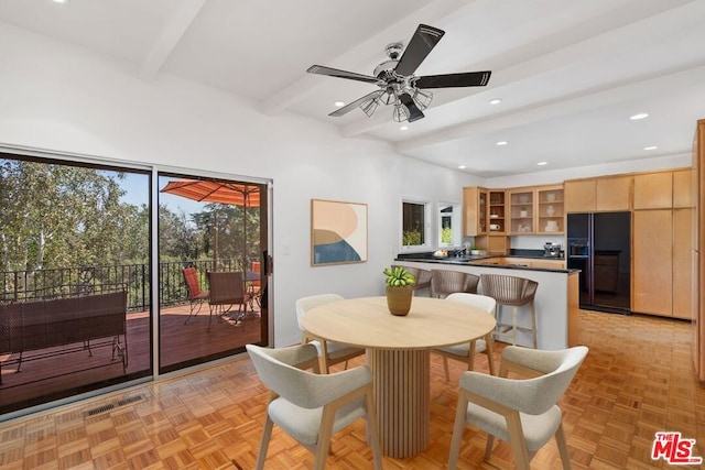 dining room with beamed ceiling, light parquet flooring, and ceiling fan