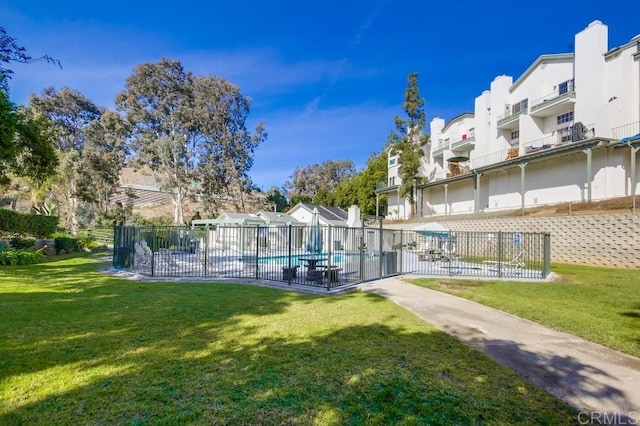 view of pool with a yard