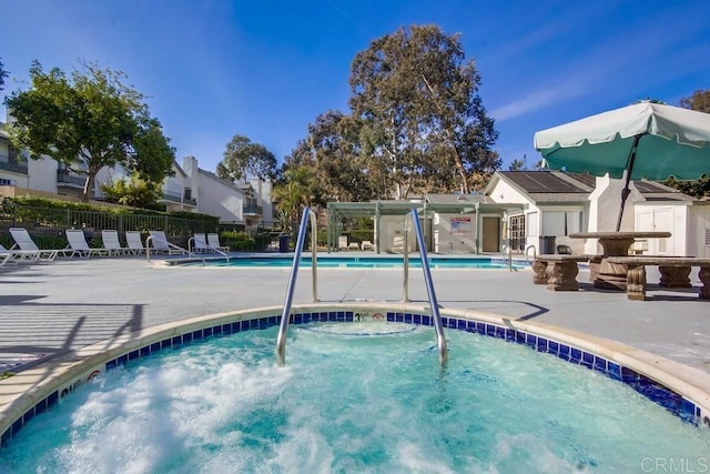 view of swimming pool featuring an outbuilding