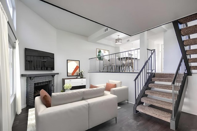 living room featuring dark hardwood / wood-style flooring and a fireplace