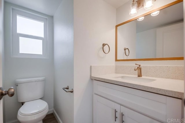 bathroom featuring toilet and vanity