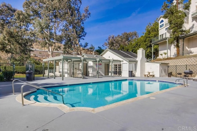 view of swimming pool with area for grilling and a patio area