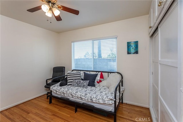 sitting room with hardwood / wood-style flooring and ceiling fan