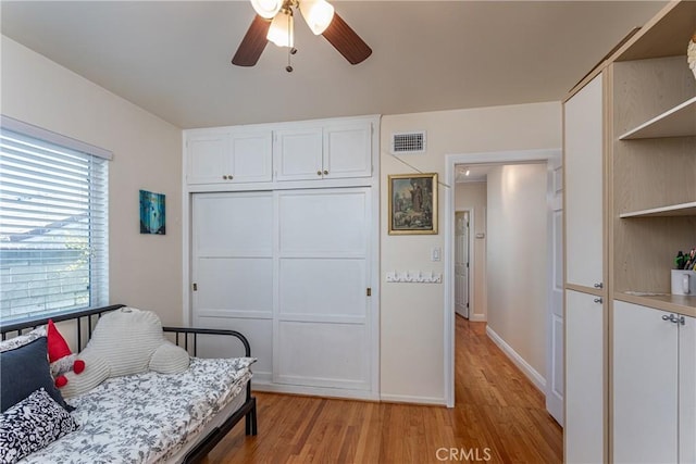 living area featuring ceiling fan and light hardwood / wood-style flooring