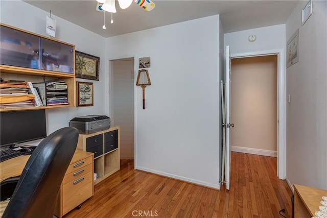 office with light hardwood / wood-style flooring