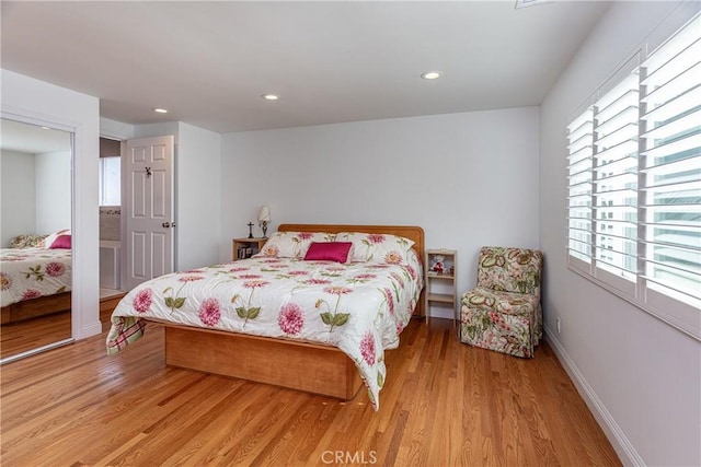 bedroom with a closet and light hardwood / wood-style floors