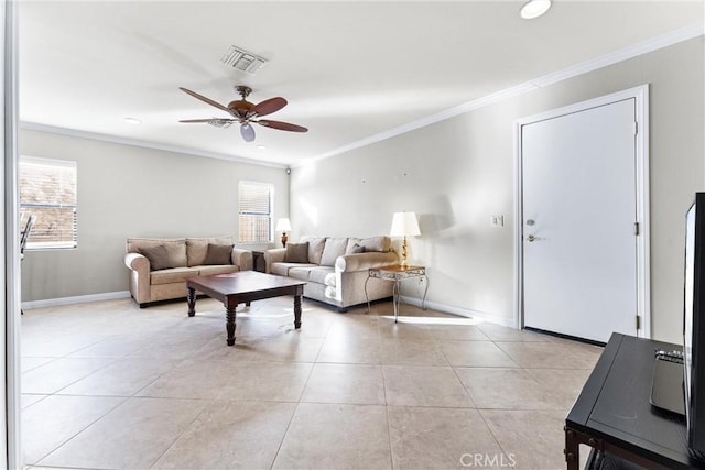 living room featuring plenty of natural light, light tile patterned floors, and ornamental molding