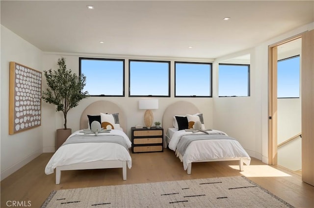 bedroom featuring light wood-type flooring and multiple windows