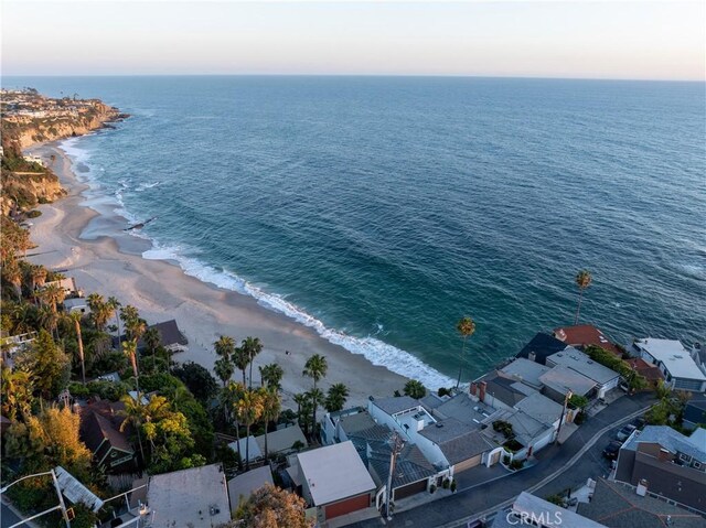 drone / aerial view featuring a water view and a view of the beach