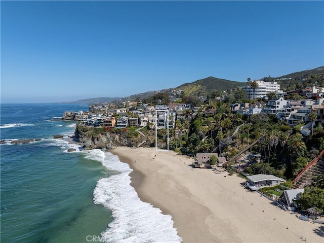 drone / aerial view with a water view and a view of the beach