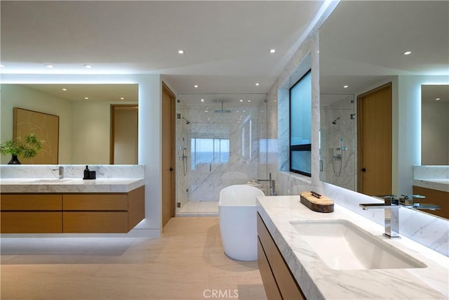 bathroom featuring walk in shower and vanity