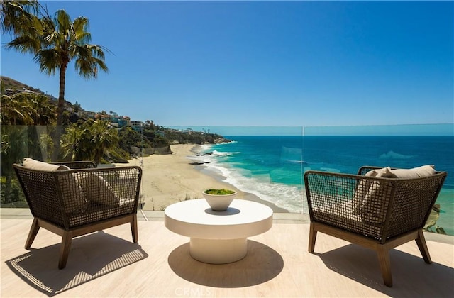 balcony featuring a water view and a beach view