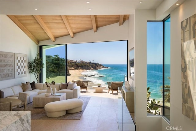 interior space with wood ceiling, a view of the beach, a water view, and vaulted ceiling with beams