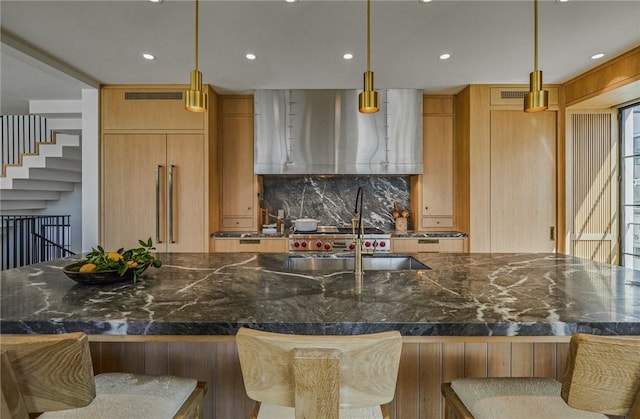 kitchen featuring pendant lighting, a large island, and a breakfast bar area