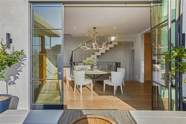 dining room with a notable chandelier, hardwood / wood-style floors, and plenty of natural light